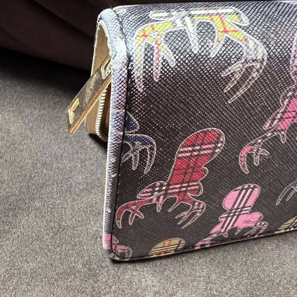 Simply southern wallet. Lots of slots for card and zips shut. Has some wear